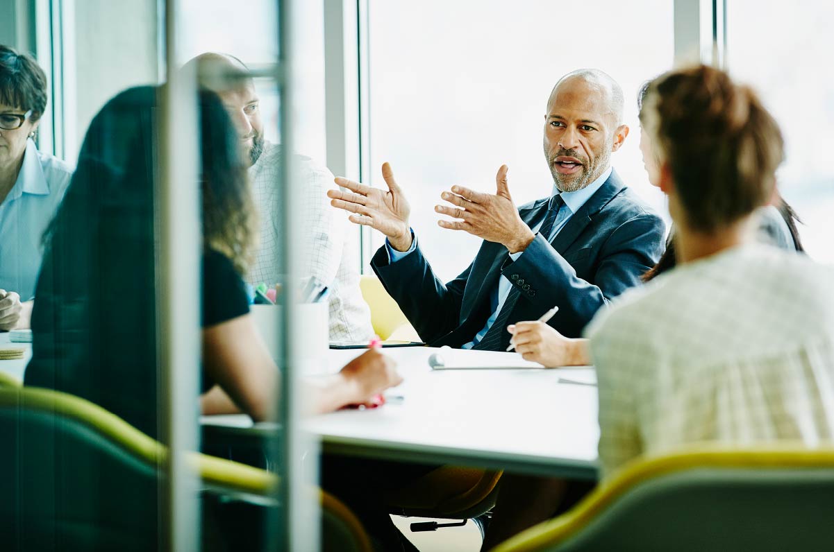 A professional explaining to a group of five other people